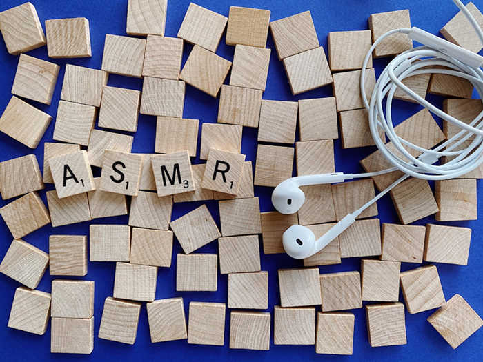 headphones and wooden blocks spelling asmr 