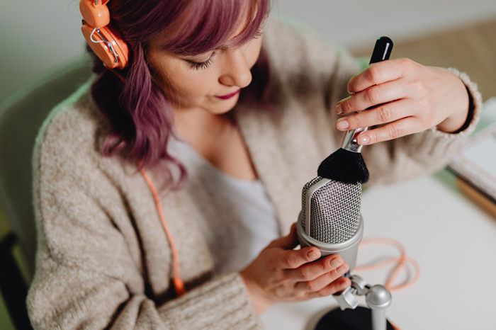 woman stroking a microphone with a brush