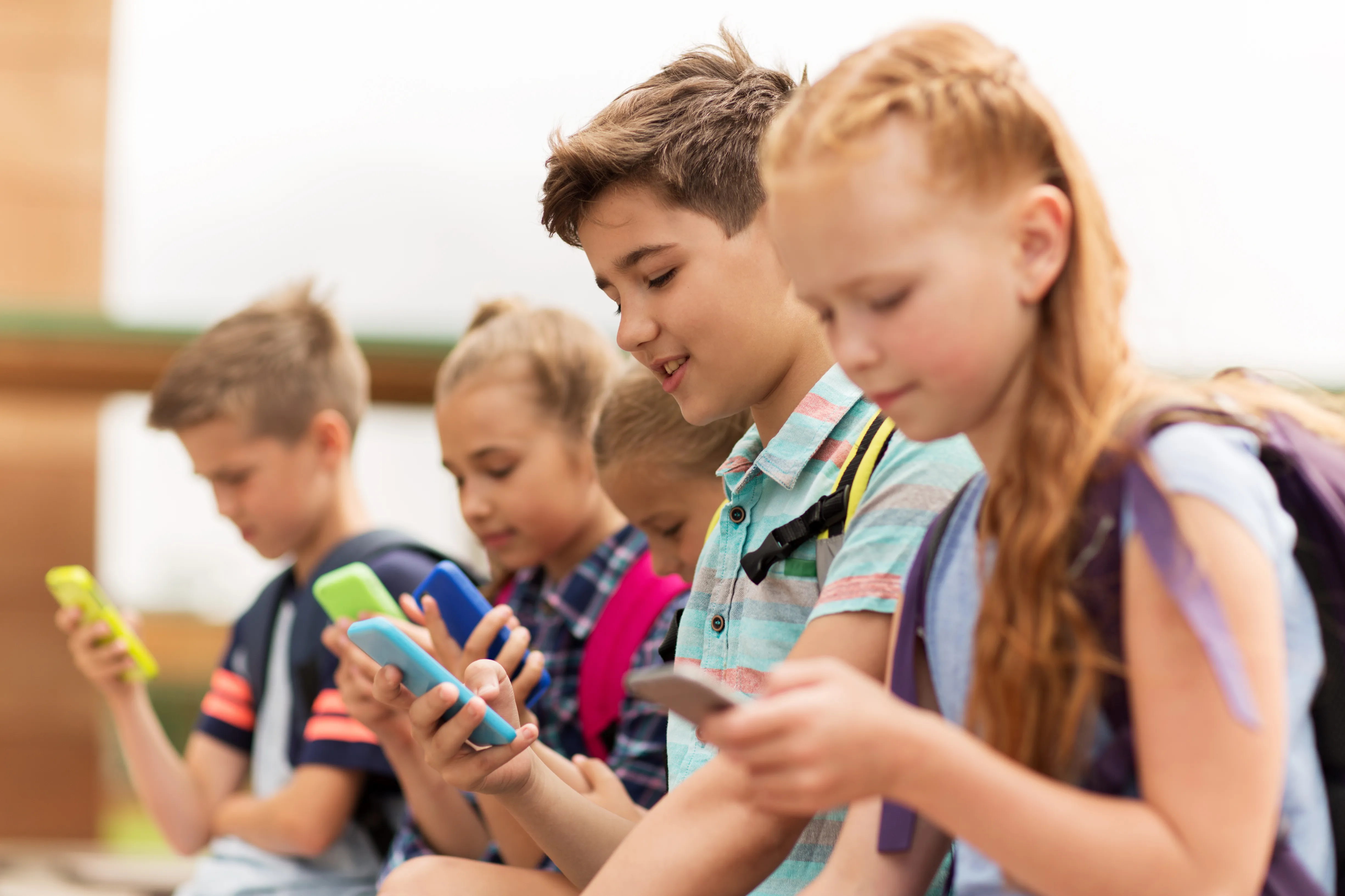  children enjoying using digital devices