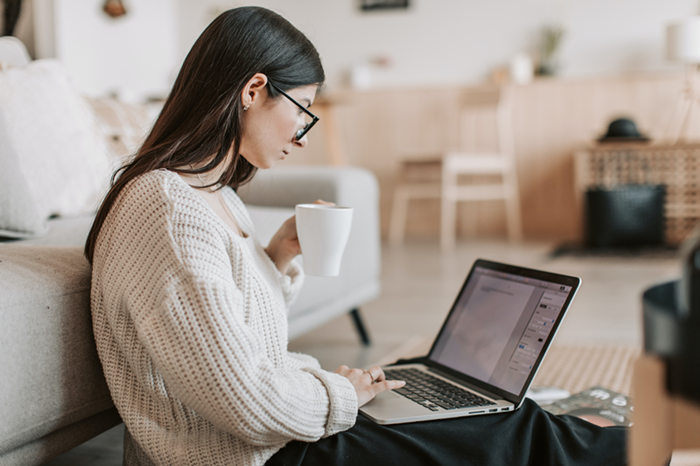 woman writing fan fiction on laptop