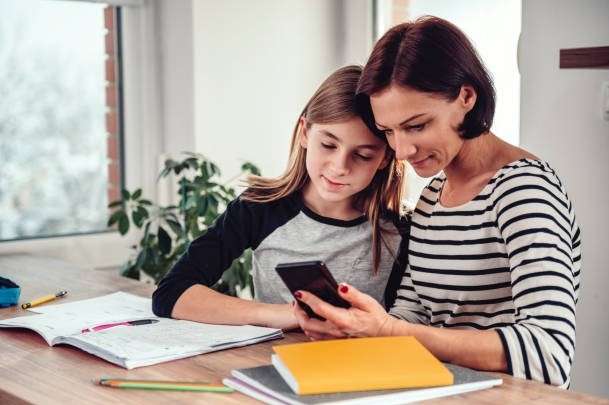  mother and daughter watch phone together